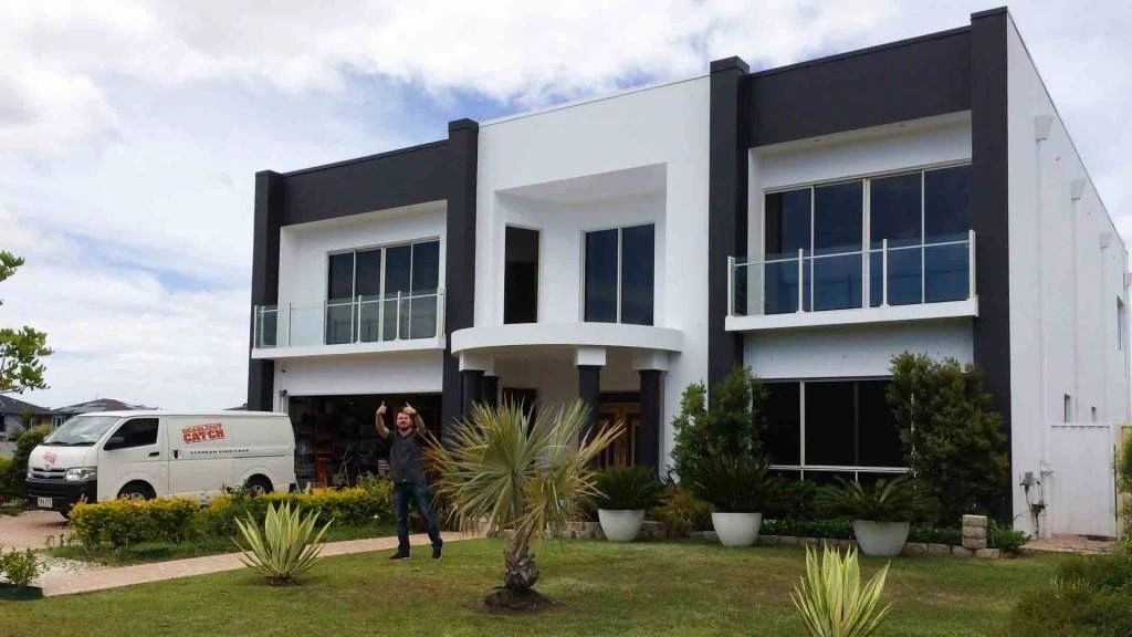 Restyling completed exterior painting project - modern two-story home
